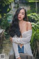 A woman with long black hair posing for a picture.